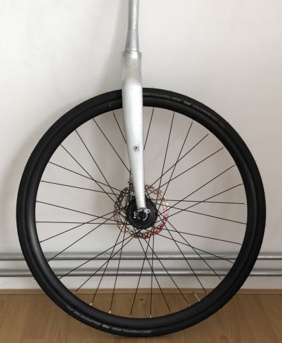 Front wheel fitted to the raw aluminium fork