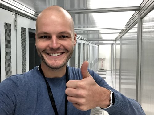 Happy engineer with Apple Watch inside the data centre!