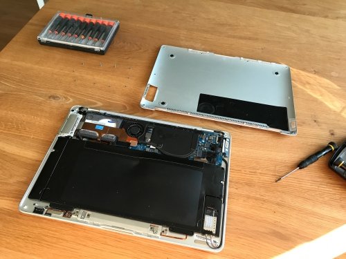 Opening the MacBook Air is possible by removing the bottom lid.