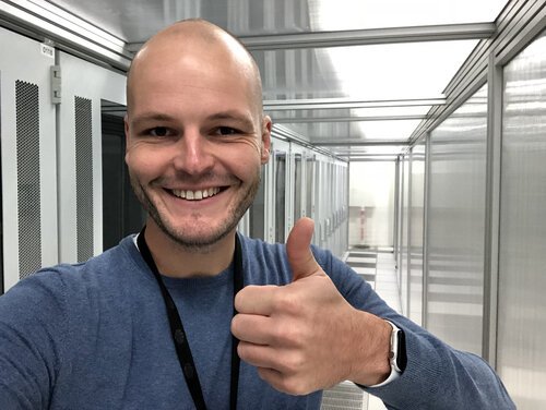 Happy engineer with Apple Watch inside the data centre!