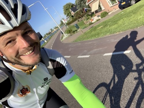 Happy chap riding a bike on an empty road