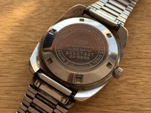 The rear of the watch, showing various numbers and markings