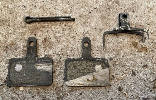 My hydraulic brake pads were worn out! Note the damaged fork in the upper right (which is supposed to keep the pads in place)