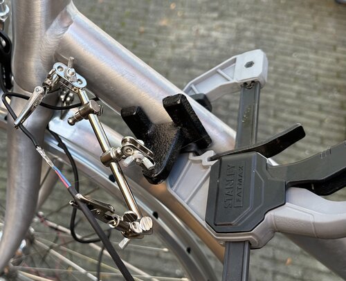 Temporarily soldering the actual cables to a copper guiding cable to enable pulling it through the bike frame