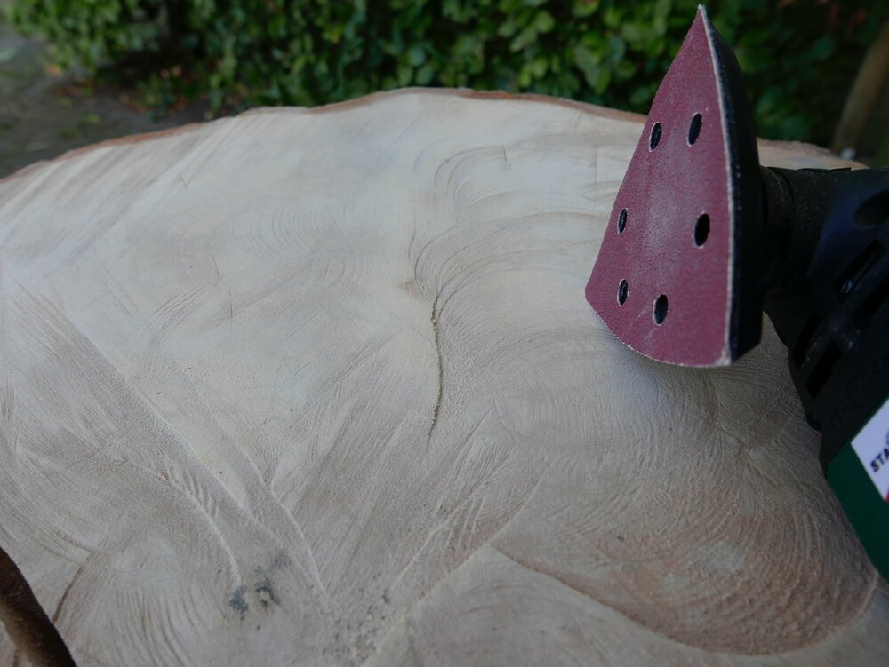 Sanding the slab of wood