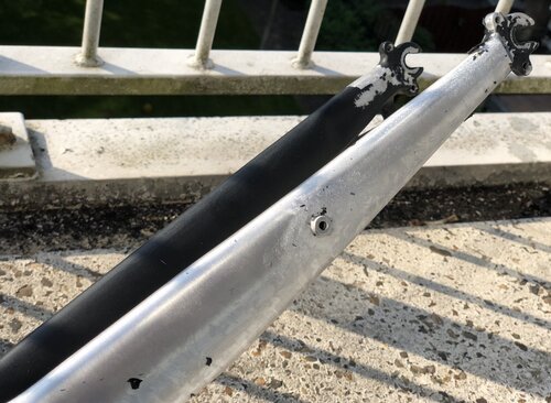 One part of the front fork uncovered, the other still painted black