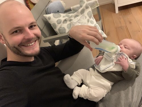 Happy boys - giving and taking a bottle of milk