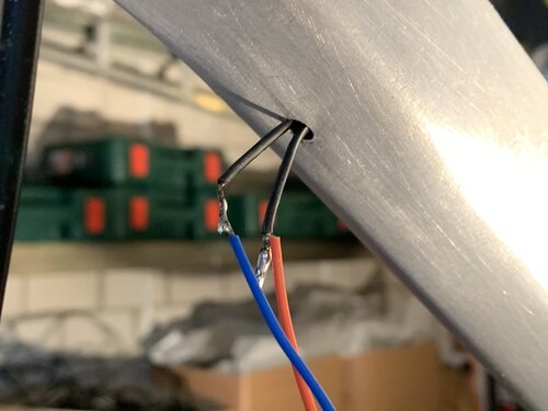 New cable soldered to the old one, allowing it to pull the new one through the bike frame