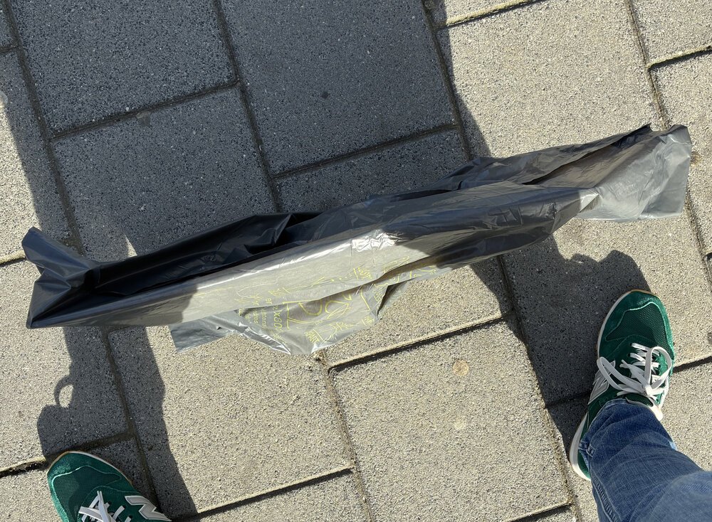 Waiting on the platform for my train with an Apple in a bag...
