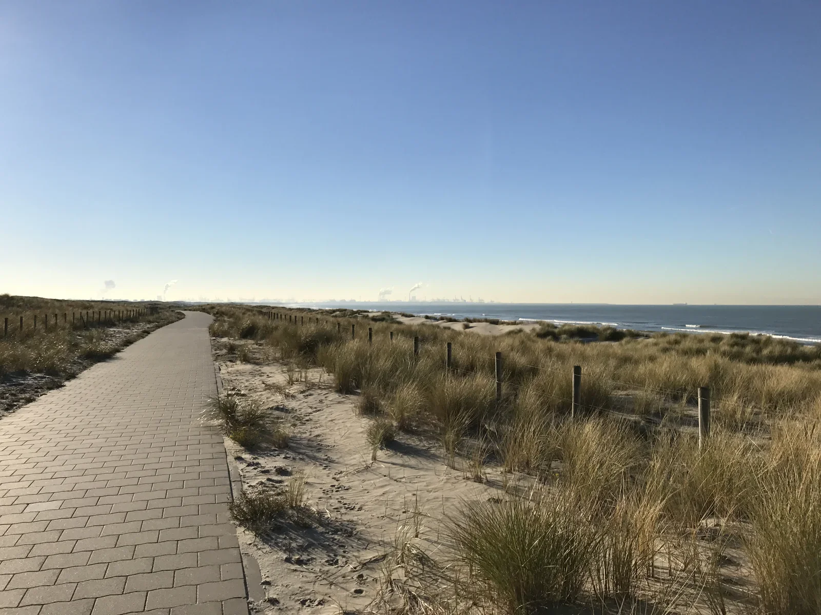 In the Netherlands there is no shortage of dykes. Many of them have long straight bike lines on them. This one is near "Hoek van Holland", you can see the Rotterdam Maasvlakte industry at the horizon.