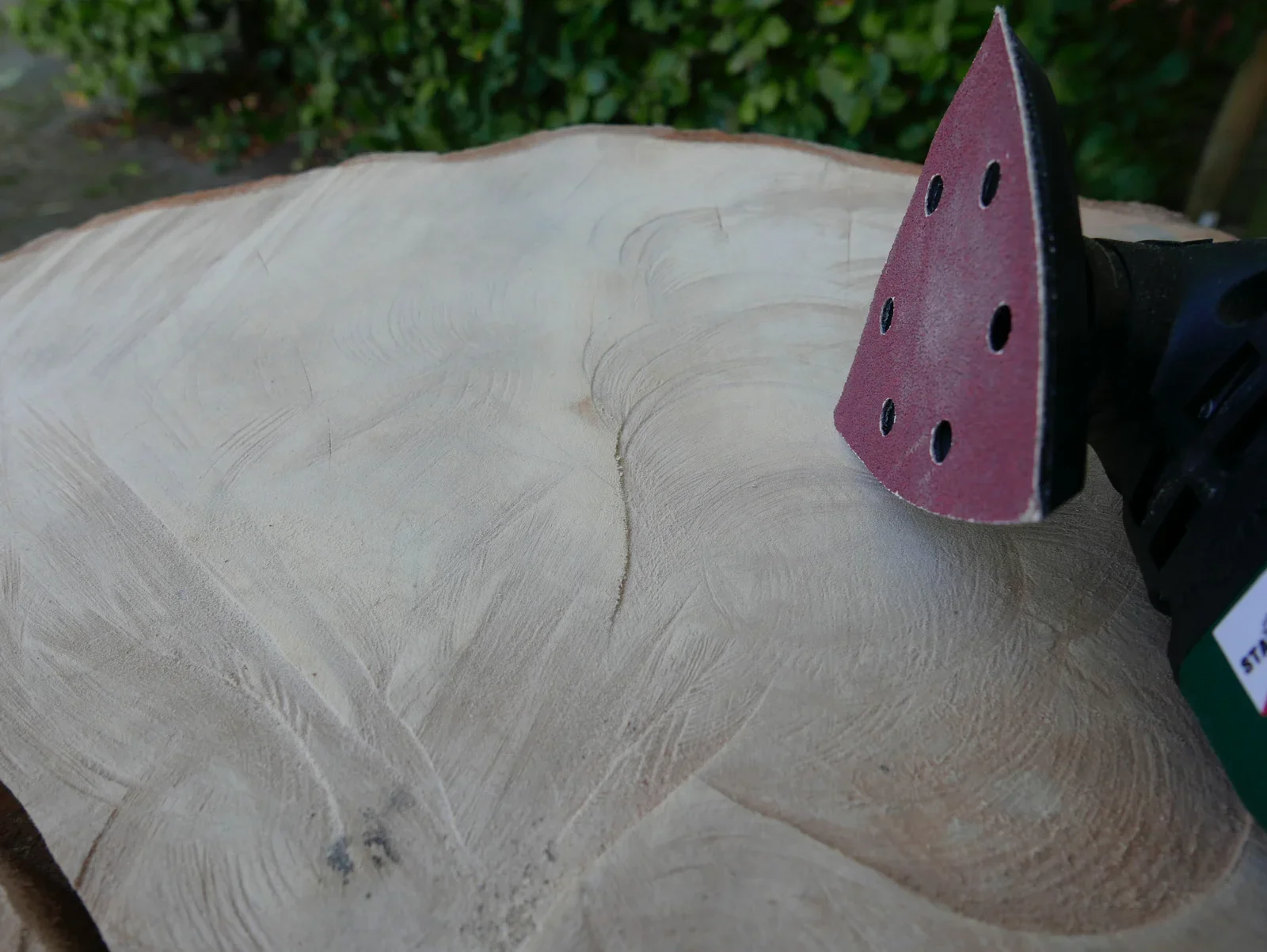 Sanding the slab of wood