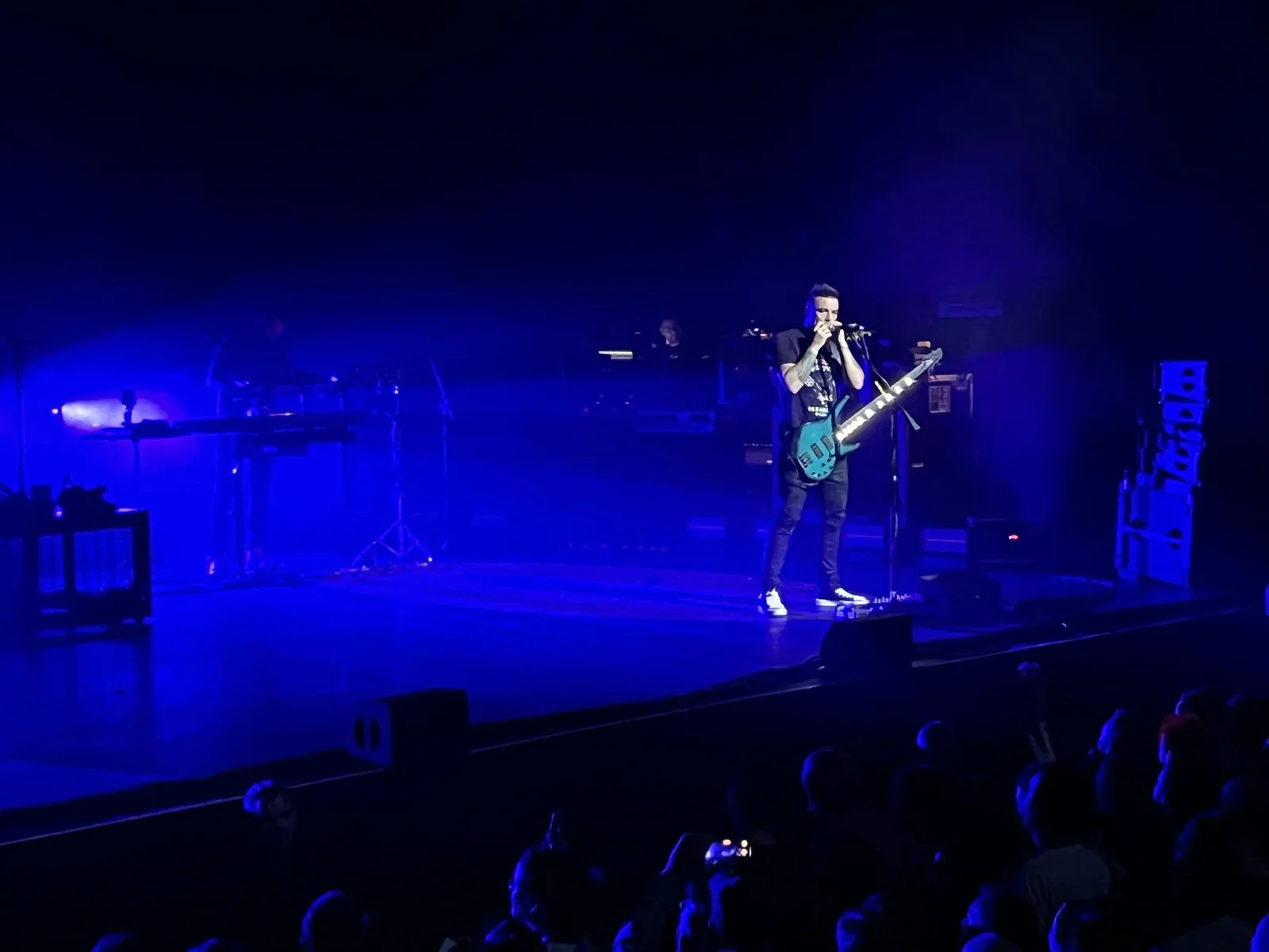 Chris Wolstenholme playing the harmonica for the "Knights of Cydonia" finale