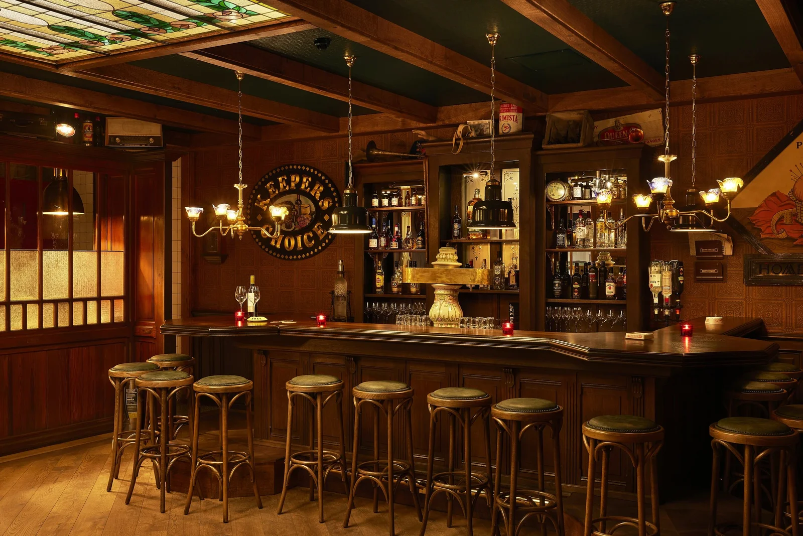 A wood-panelled bar with brass chandeliers. Photo: Kevin Middelkoop