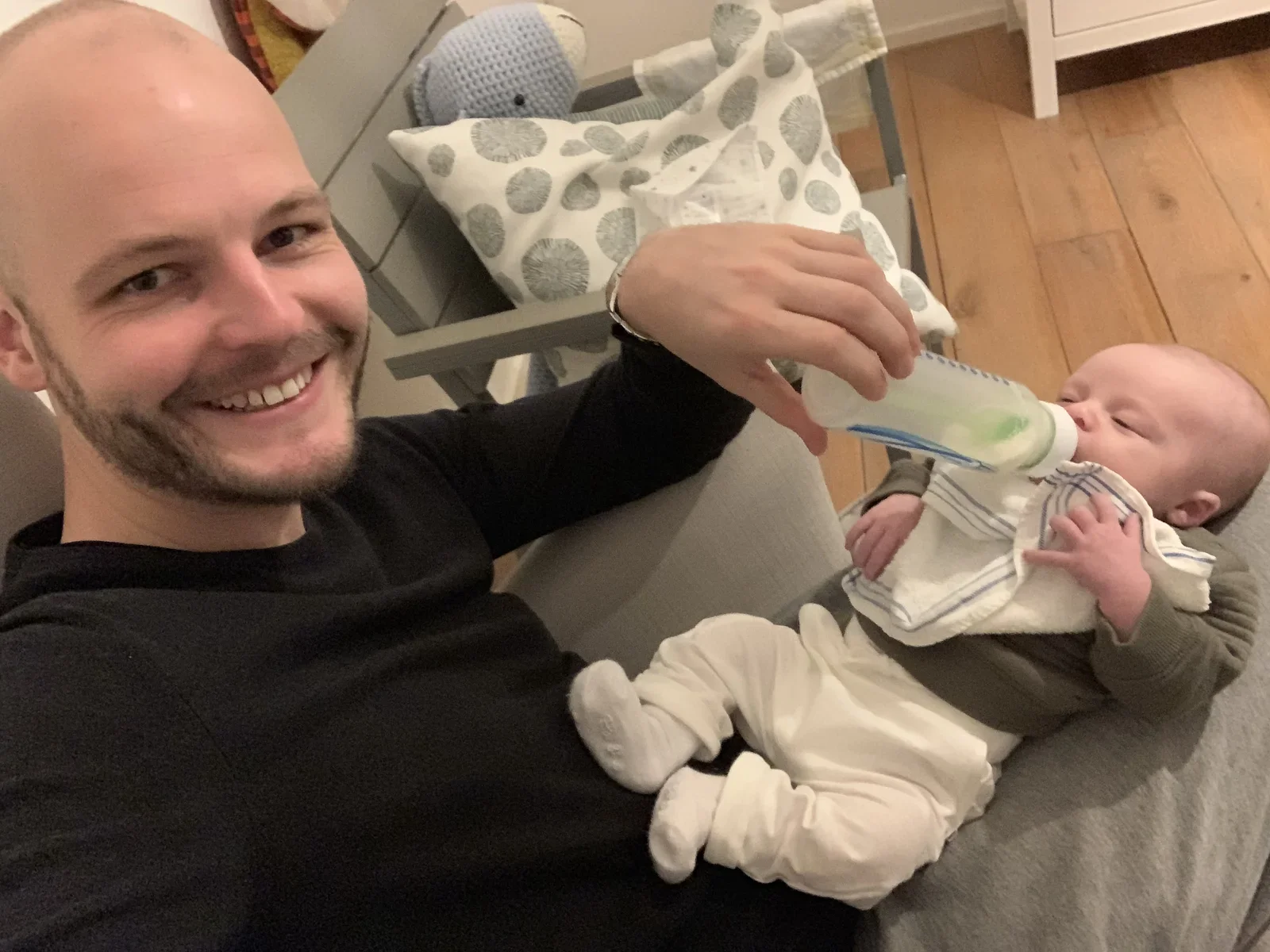 Happy boys - giving and taking a bottle of milk
